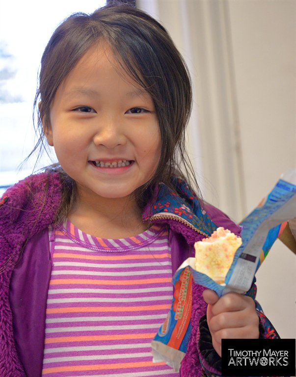little girl eating ice cream bar