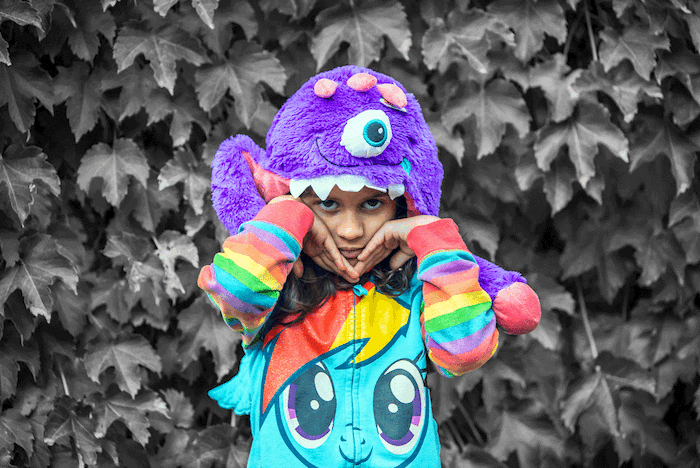 Little girl wearing purple monster hat
